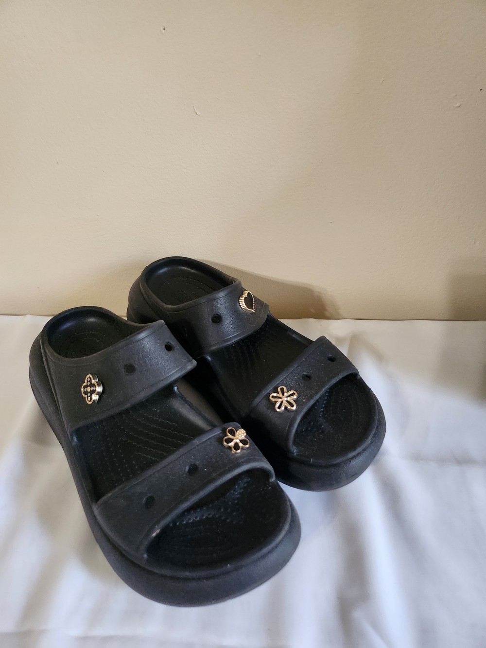 Crocs Black Slide Sandals with Gold Flower Accents